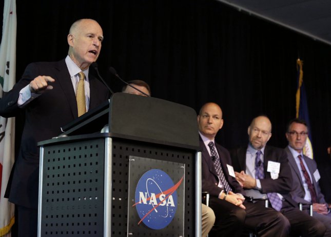 California Gov. Jerry Brown speaks to researchers and scientists during a call to action on climate change at the Water, Energy and Smart Technology Summit and Showcase at NASA Ames Research Center Thursday, May 23, 2013 in Mountain View, Calif. Listening from left, are panelists Waleed Abdalati, James E. Hansen, Dr. Anthony D. Barnosky, and Banny Banerjee. Brown warned scientists and policymakers Thursday that they are losing the war on climate change and urged them to become advocates for the planet.  (AP Photo/Eric Risberg)
